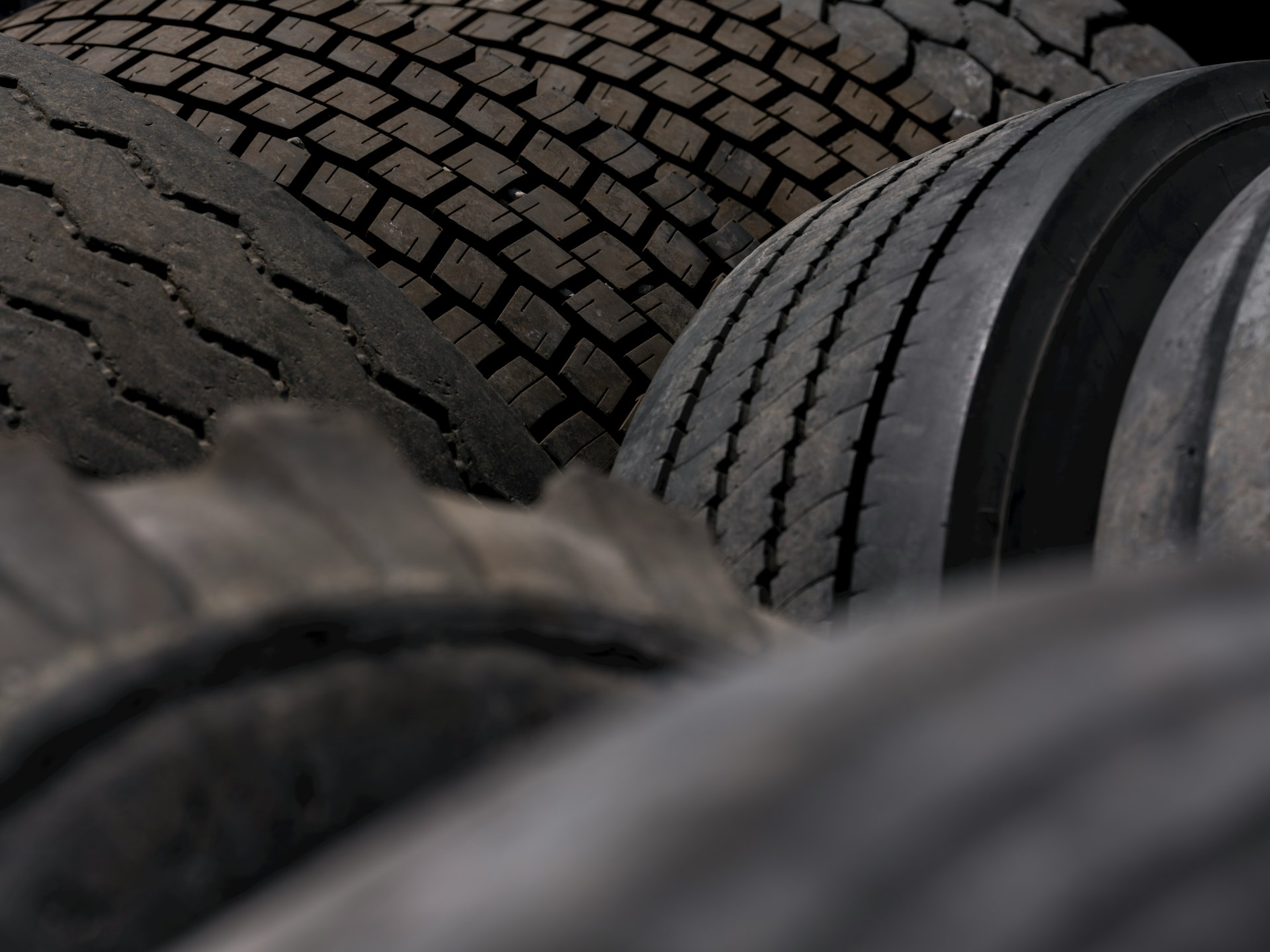 Close up of stacked truck tires with worn treads